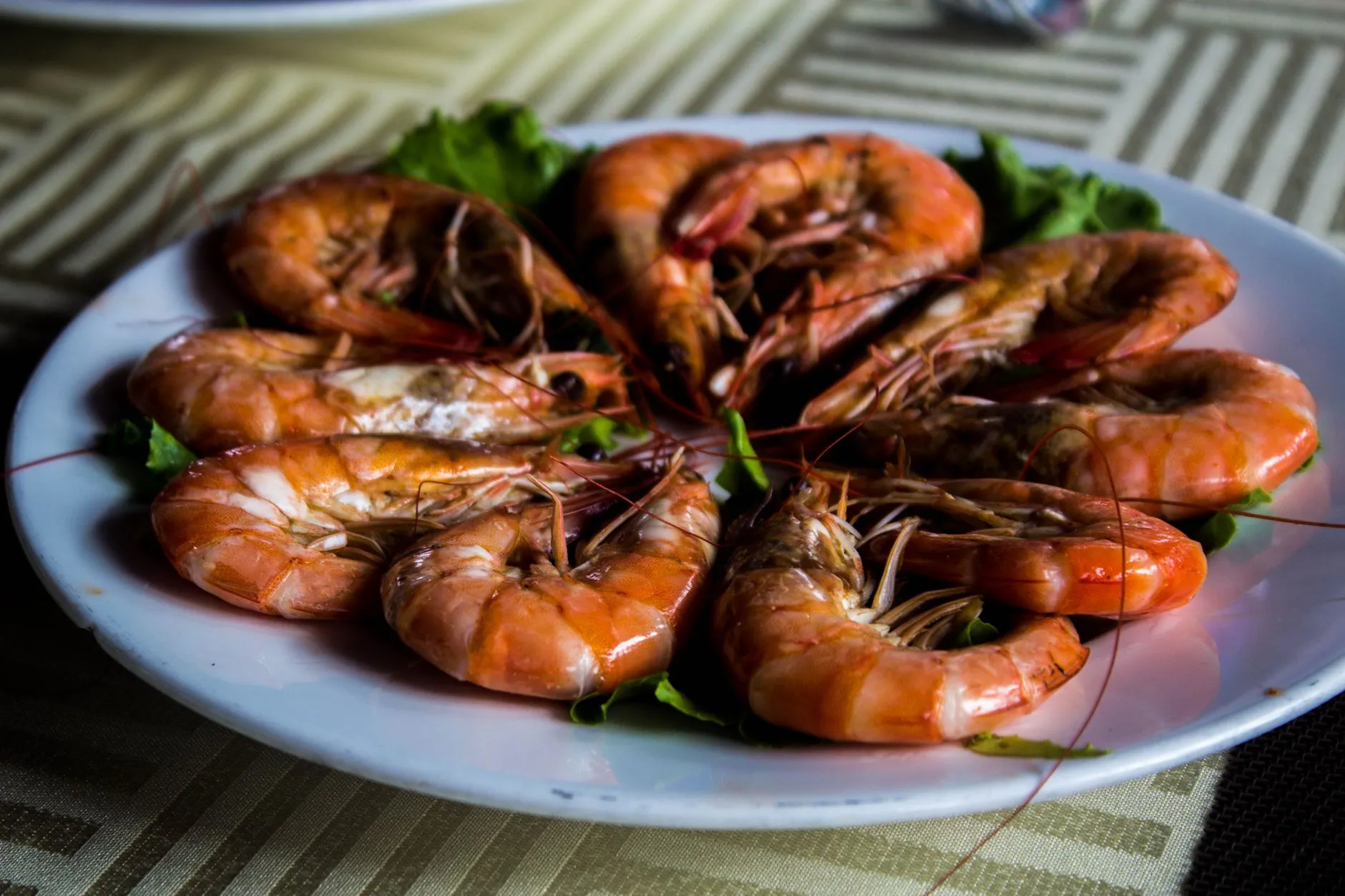 A close-up of a plate with cooked prawns, showcasing a delicious Vietnamese dish.
