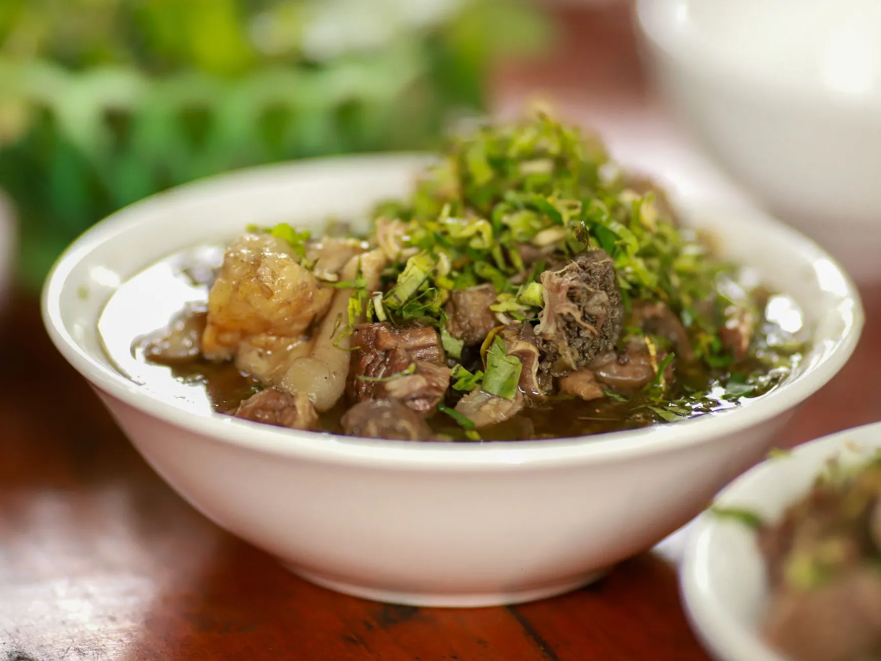 A flavorful Vietnamese dish featuring meat and fresh herbs in Lào Cai, Vietnam.