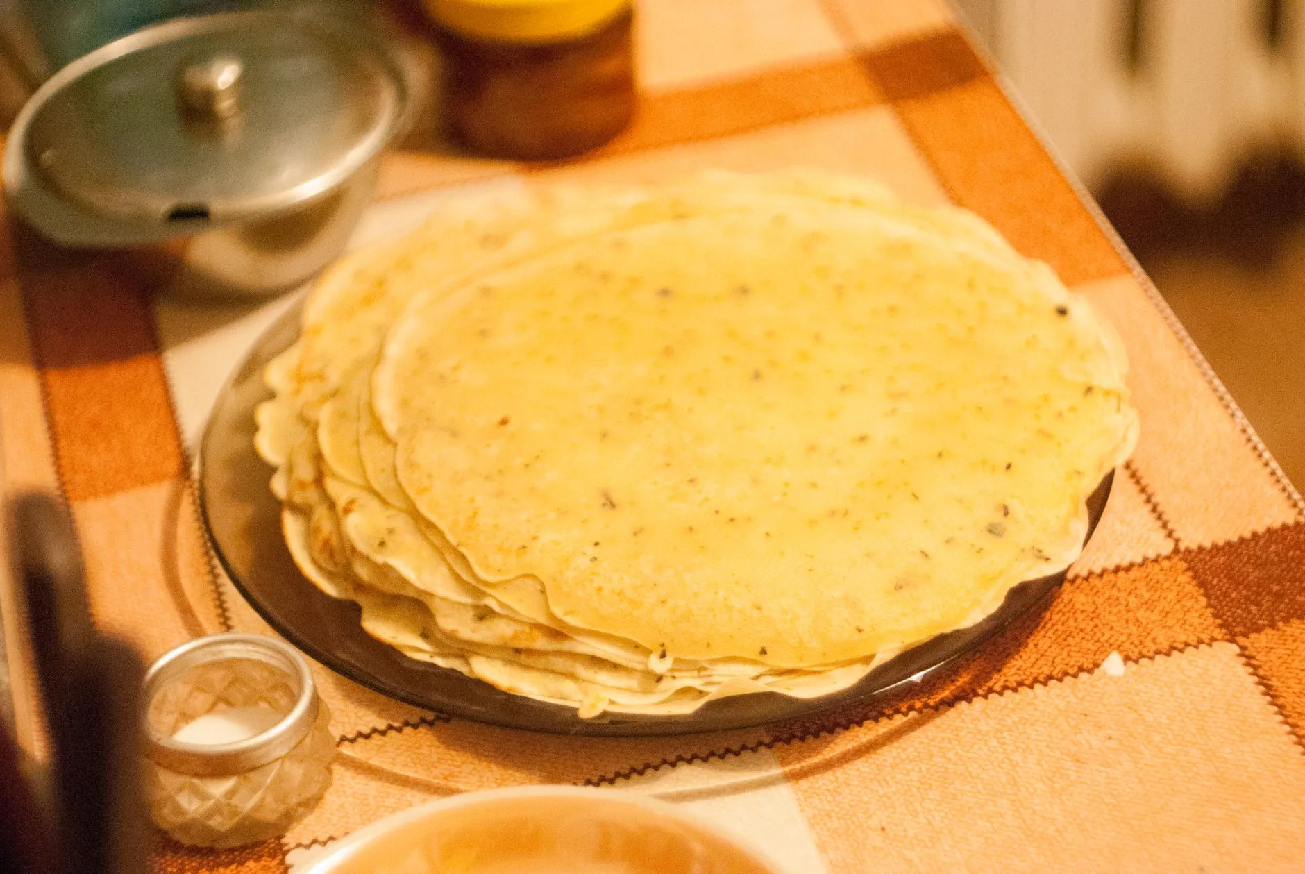 A close-up shot of a stack of delicious homemade tortillas on a rustic table setting.